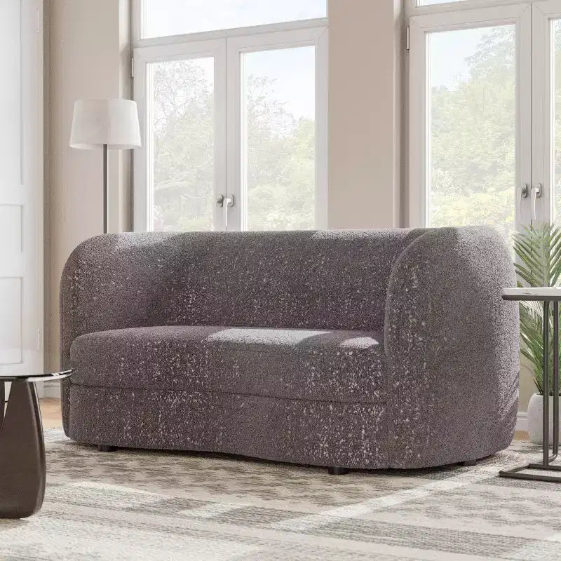 Divanetto curvo in tessuto bouclé Boho con cuscini a molle insacchettate