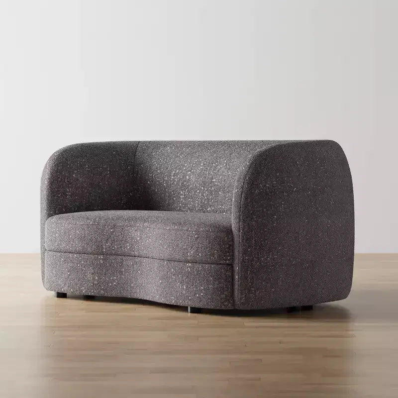 Divanetto curvo in tessuto bouclé Boho con cuscini a molle insacchettate