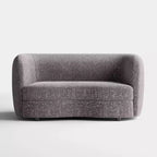 Divanetto curvo in tessuto bouclé Boho con cuscini a molle insacchettate