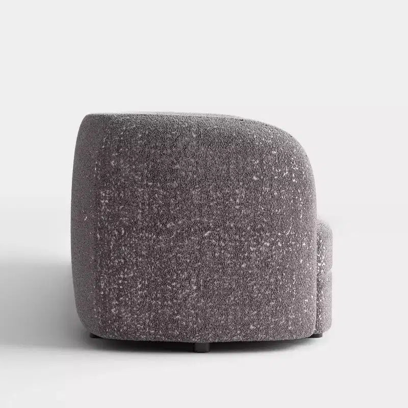 Divanetto curvo in tessuto bouclé Boho con cuscini a molle insacchettate